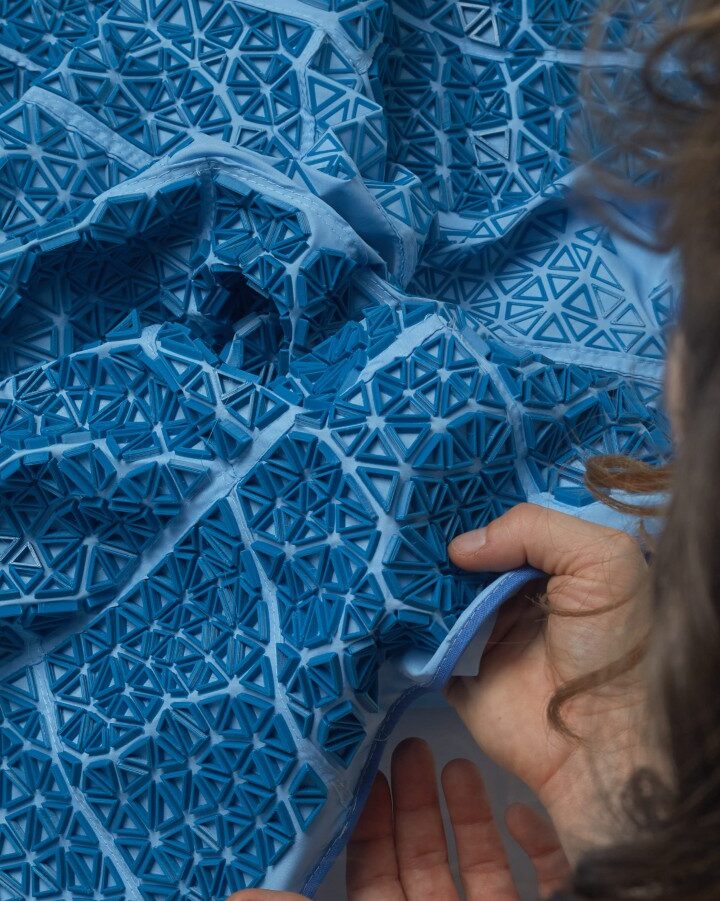 Ganit Goldstein with a 3D-printed fabric made of recycled materials including water bottles. The fabric can be examined in detail through her unique VR fashion exhibition. Credit: courtesy
