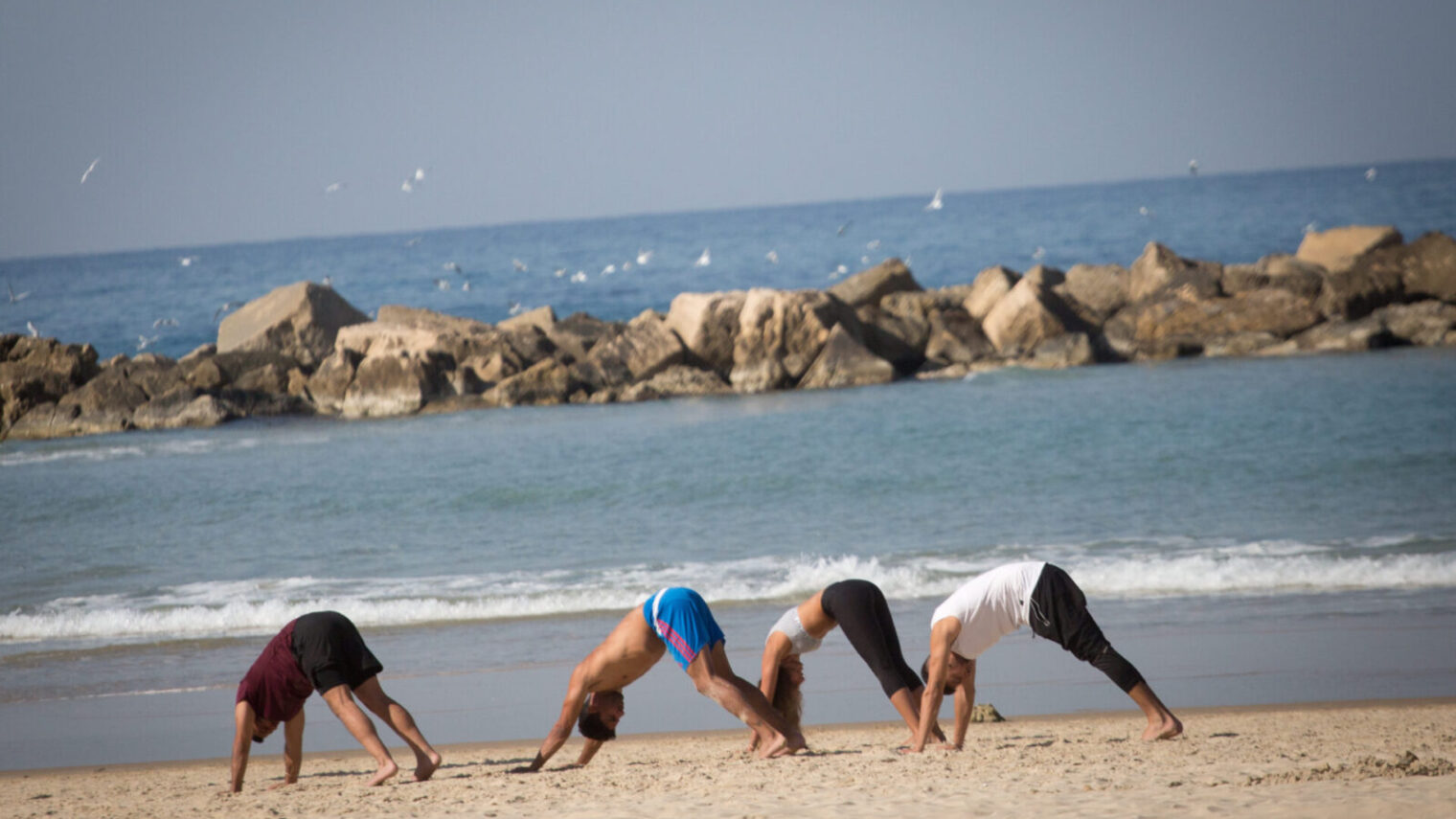 Israelis take their exercise to the beach in Tel Aviv during lockdown,December 30, 2020. Photo by Miriam Alster/Flash90
