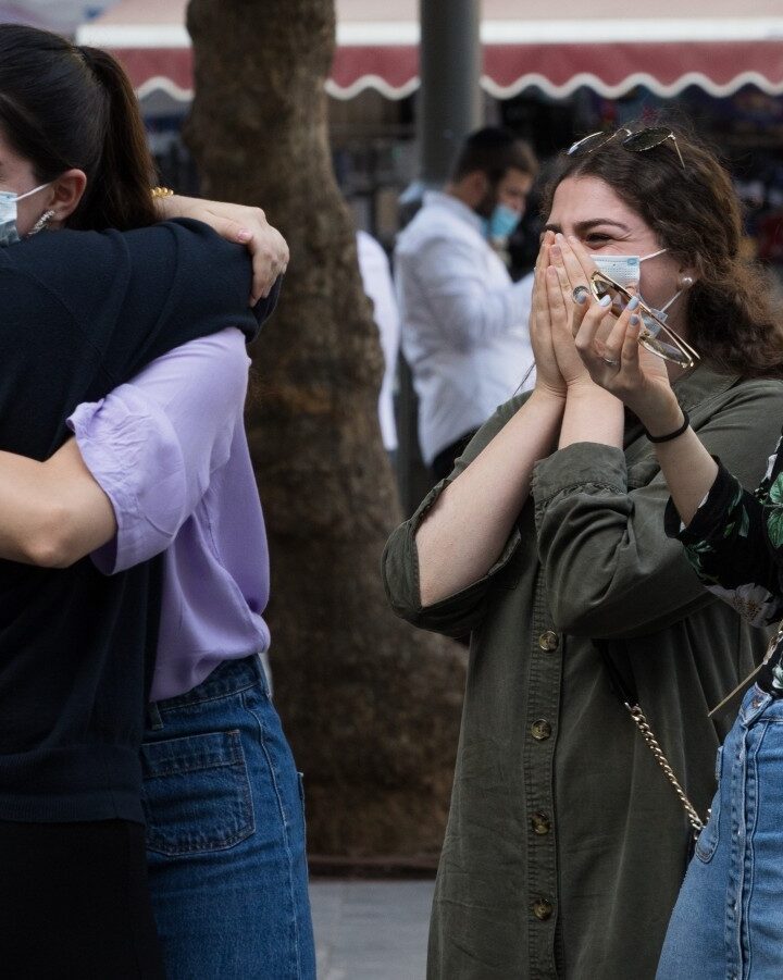 Women hug on Jaffa Street in downtown Jerusalem on October 25, 2020. Photo by Nati Shohat/Flash90