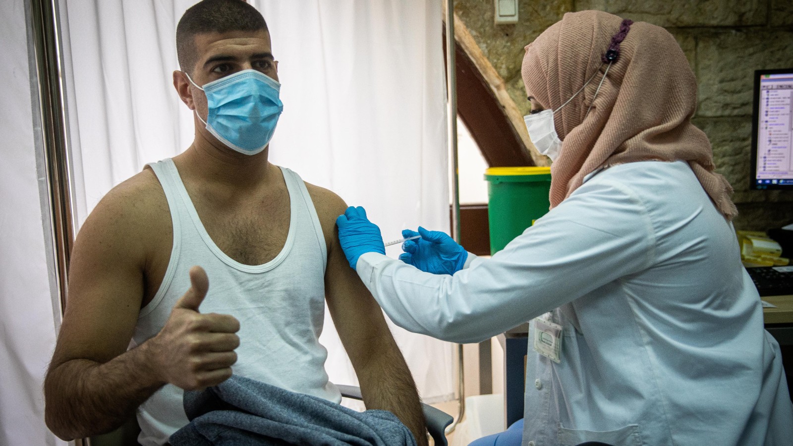 A nurse giving a Covid-19 vaccine in Jerusalem, December 24, 2020. Photo by Yonatan Sindel/Flash90