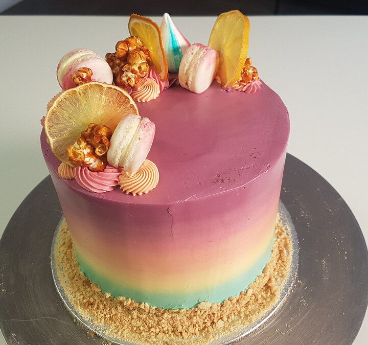 Forget your troubles and brighten your day with this stunning rainbow cake. Photo still from film