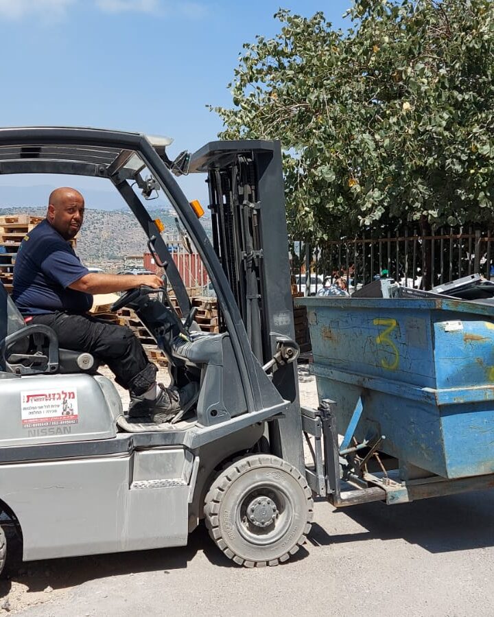 An Ecommunity worker operating a forklift. Photo courtesy of Ecology for Protected Community
