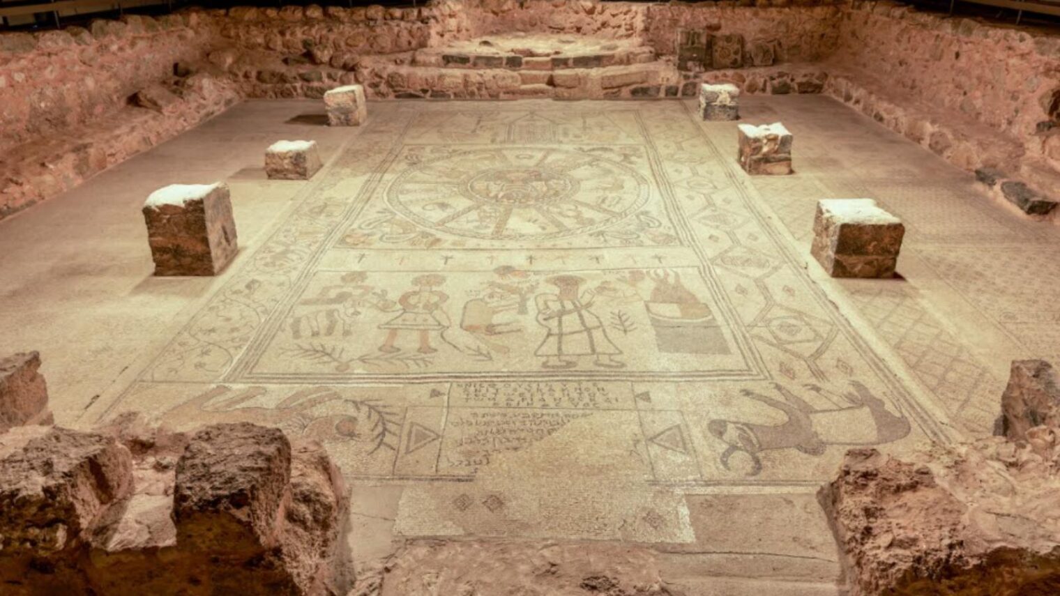 The magnificent mosaic at the fifth century Beit Alpha synagogue in northern Israel depicts Jewish themes such as a tabernacle, menorahs, an etrog, a shofar and lions; a zodiac featuring the Greek sun god Helios surrounded by the Hebrew name for each star sign and female figures representing the four seasons; and the biblical story of the binding of Isaac. The father-and-son artisans Mariunus and Hanina inscribed their names into the mosaic. Photo by Boaz Eshkol