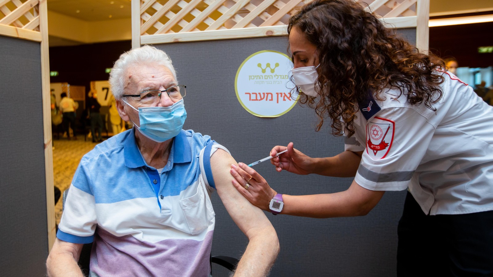 A MDA employee administers the first dose of the Covid-19 vaccine to a resident of Mediterranean Towers retirement community. Photo courtesy of Magen David Adom Spokesman’s Office