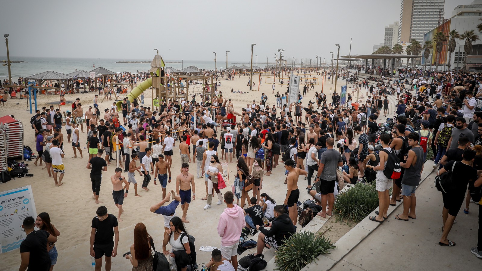 Israelis are returning to public places – like this beach in Tel Aviv -- after more than half the population is vaccinated. Photo by Noam Revkin Fenton/Flash90