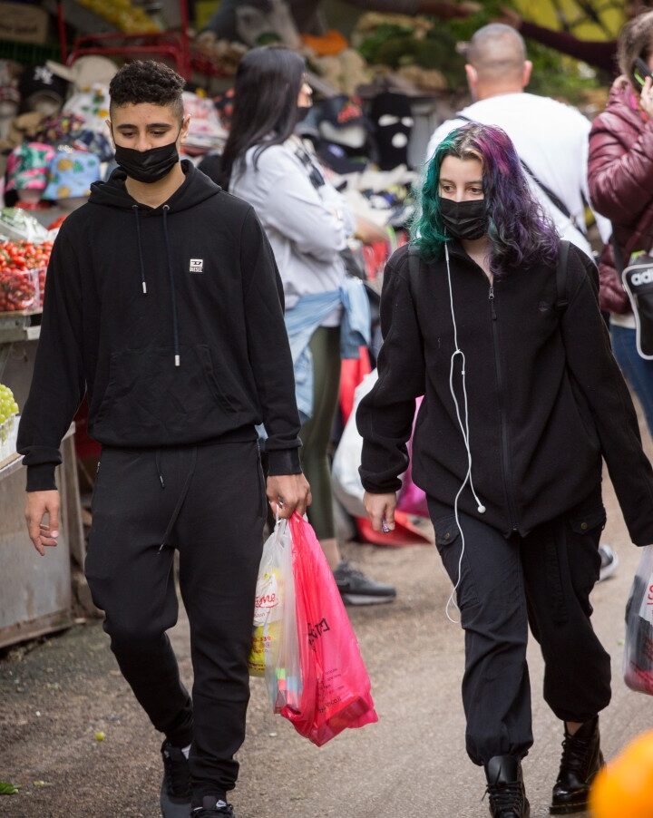 Israelis wear facemasks as they shop at Carmel Market in Tel Aviv, March 1, 2021. Photo by Miriam Alster/FLASH90
