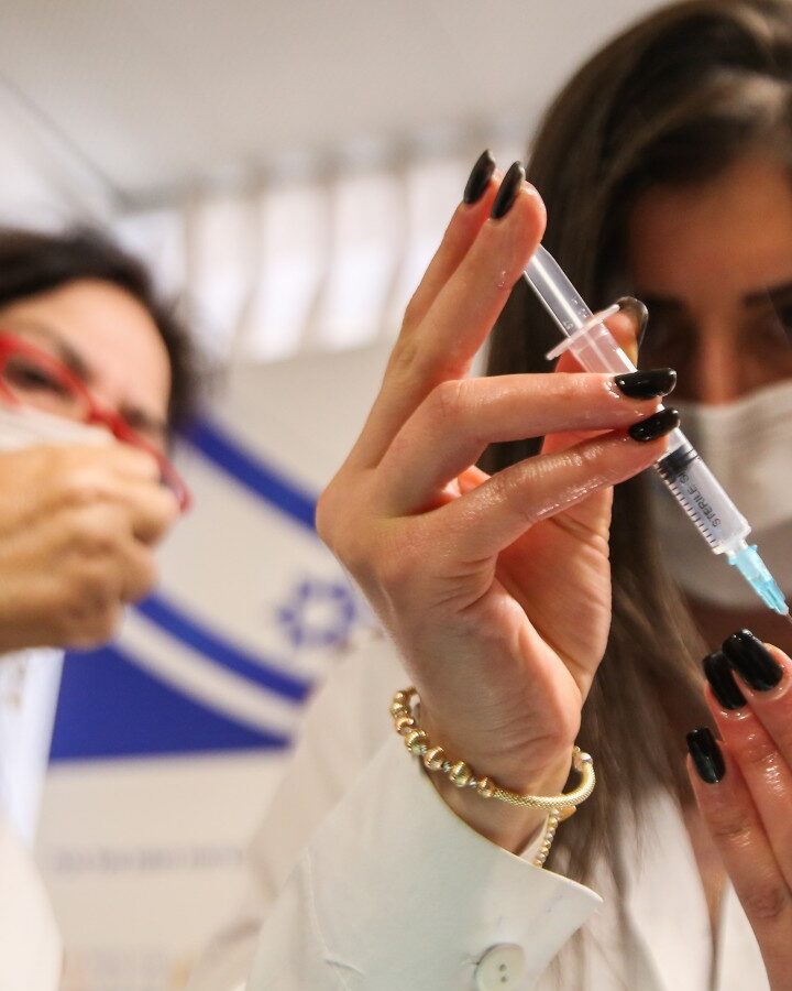 A medical worker prepares a Covid-19 vaccine injection at Ziv Medical Center in the Safed. Photo by David Cohen/Flash90