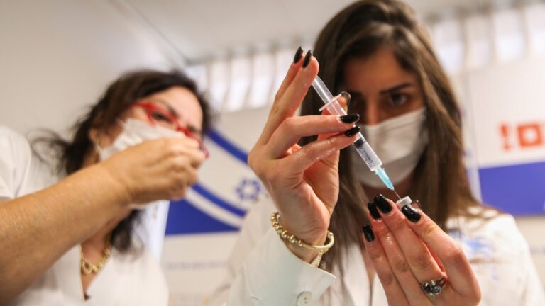 A medical worker prepares a Covid-19 vaccine injection at Ziv Medical Center in the Safed. Photo by David Cohen/Flash90