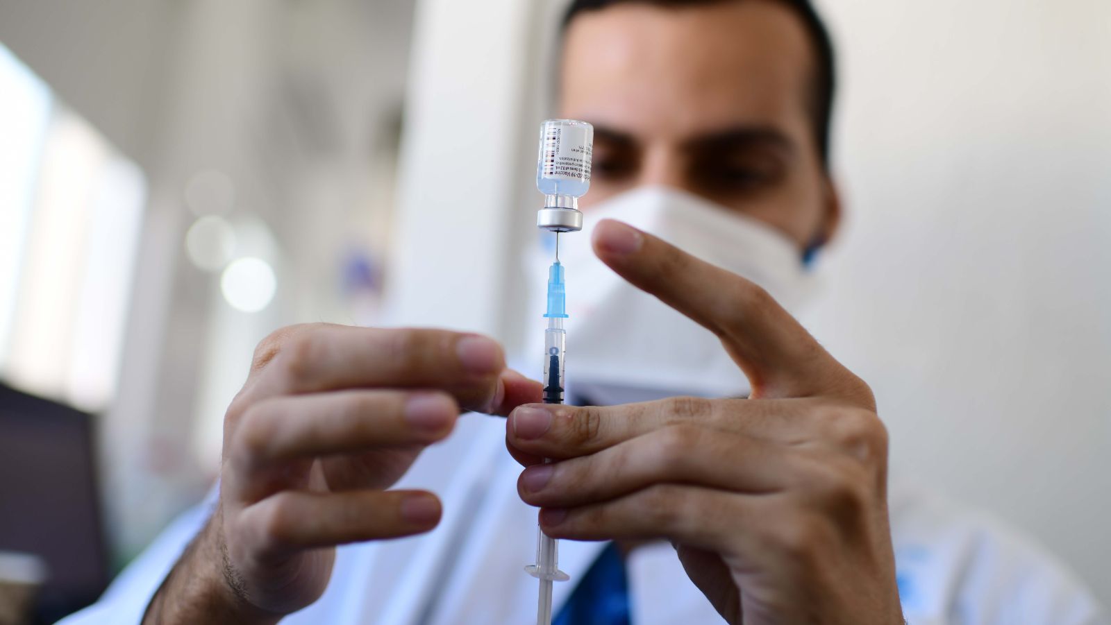 A healthcare worker readies a Covid-19 vaccine in Tel Aviv in February 2021. Photo by Tomer Neuberg/Flash90