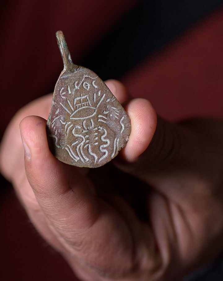 The reverse side of an ancient bronze amulet found near the ruins of the Arbel synagogue in northern Israel depicts protection against the evil eye. Photo by Dafna Gazit/Israel Antiquities Authority
