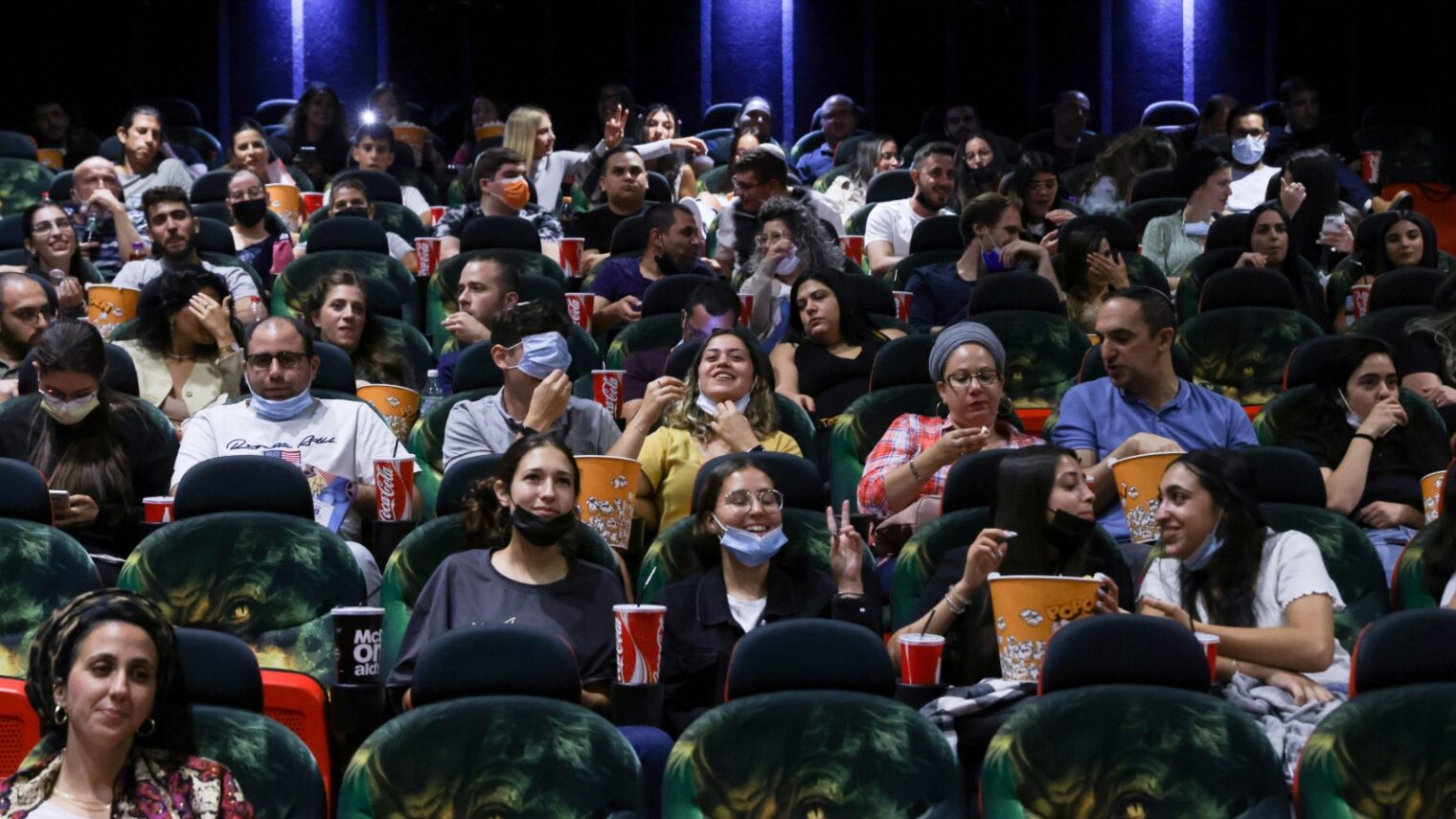 Israelis attend a movie at Cinema City Jerusalem on the official reopening night after 14 months of closure during the coronavirus pandemic. Photo by Olivier Fitoussi/Flash90