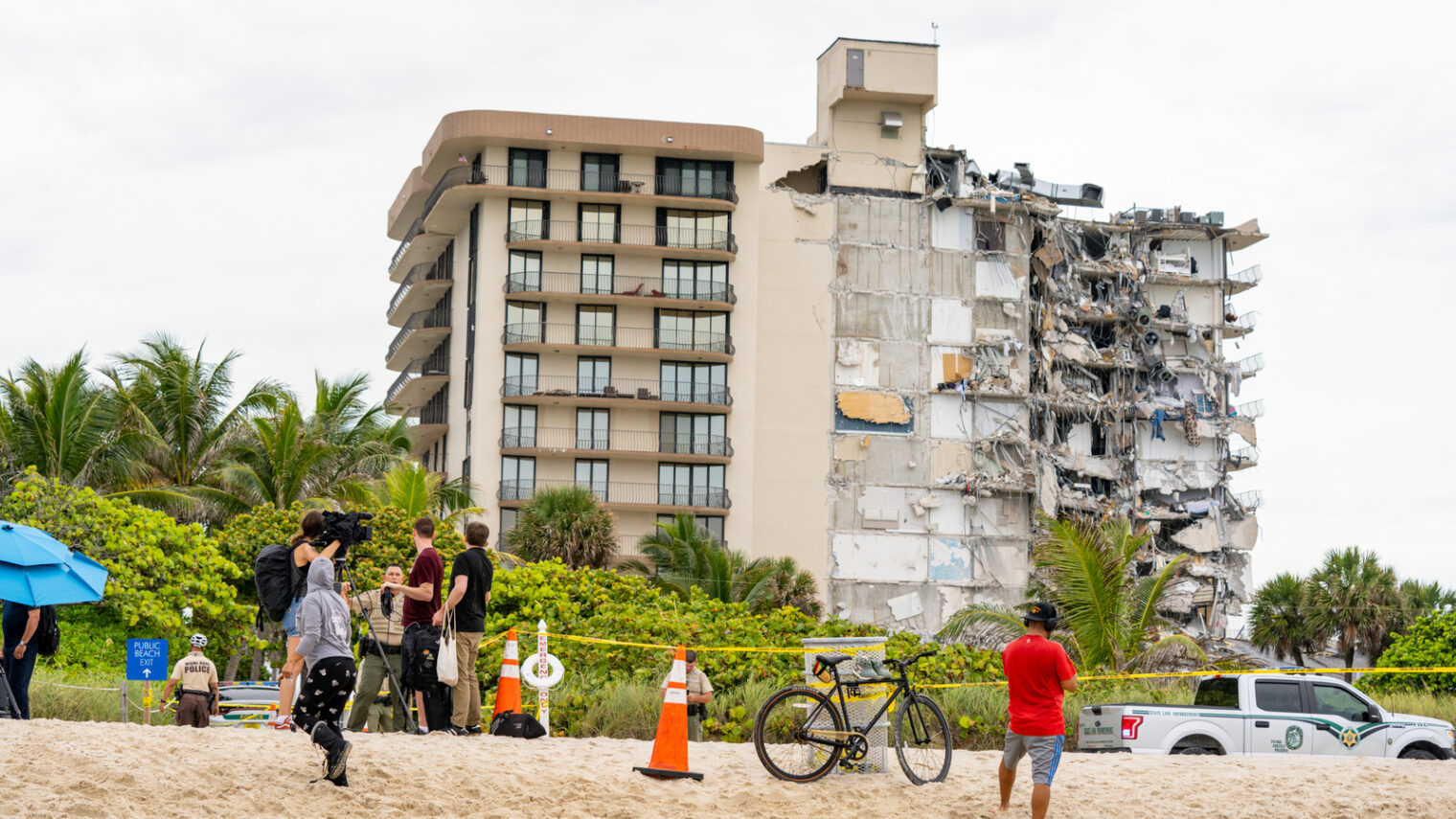 People watch a partially collapsed building in Surfside, Florida, June 24, 2021. Photo by Fernando Medina via Shutterstock.com