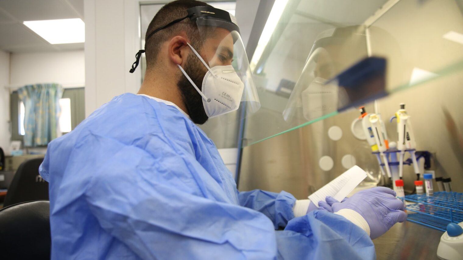 A technician carries out a diagnostic test for coronavirus at Ziv Medical Center in Safed. Photo by David Cohen/Flash90