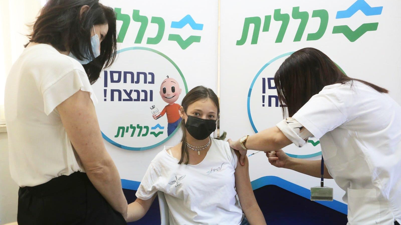 Prime Minister Naftali Bennett's daughter Michal Bennett, 14, accompanied by her mother, Gilat, receiving her coronavirus vaccine on June 29, 2021, at a Clalit Health Services clinic in Ra'anana. Photo by Nimrod Glickman, Clalit Health Services (Sharon-Samaria District) Spokesperson's Office