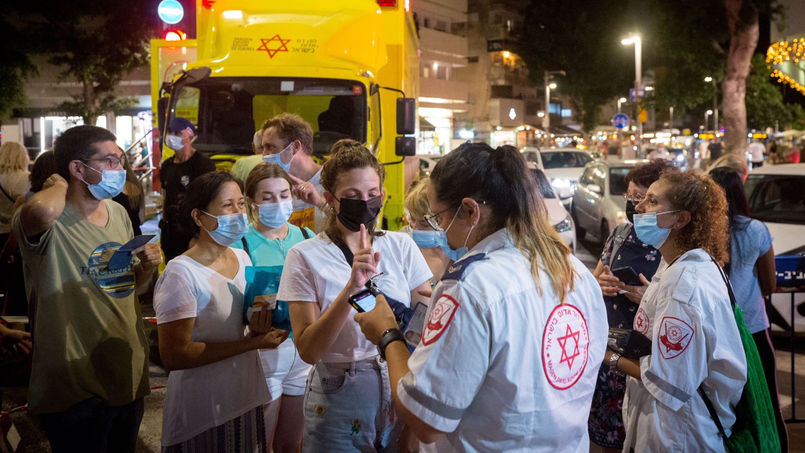 Israelis stand in line at a nighttime mobile Covid vaccination site at Dizengoff Square in Tel Aviv, August 14, 2021.  Photo by Miriam Alster/Flash90