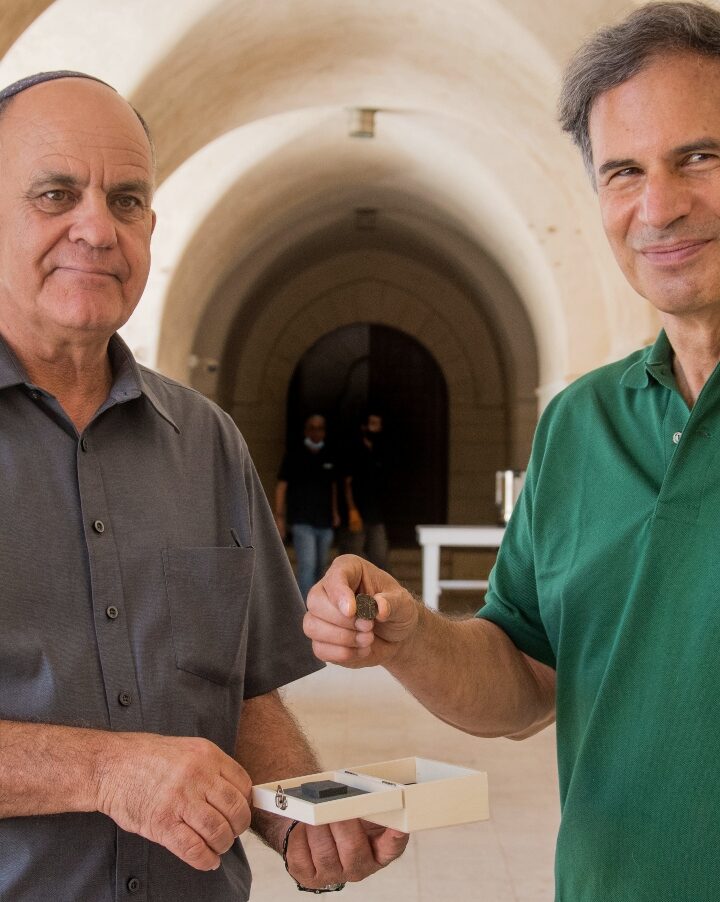 IAA Director Eli Eskosido, left, presents Israeli astronaut Eytan Stibbe with an ancient coin for guardianship while on his trip to space. Photo by Yoli Schwartz/IAA