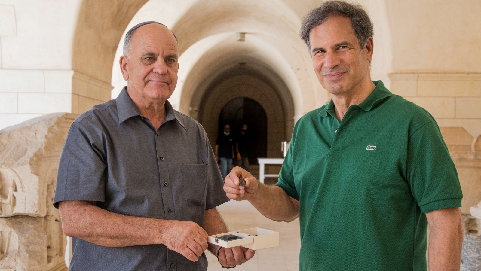 IAA Director Eli Eskosido, left, presents Israeli astronaut Eytan Stibbe with an ancient coin for guardianship while on his trip to space. Photo by Yoli Schwartz/IAA