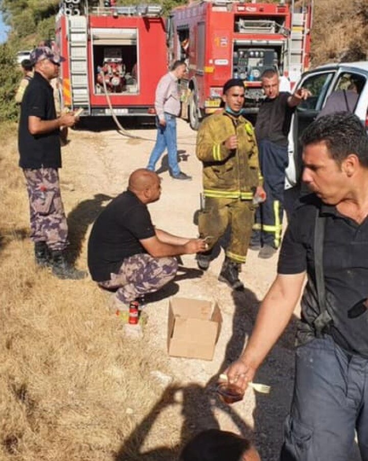 Israeli and Palestinian Authority firefighters on a lunch break while battling wildfires outside Jerusalem, August 17, 2021. Photo by Haim Omri