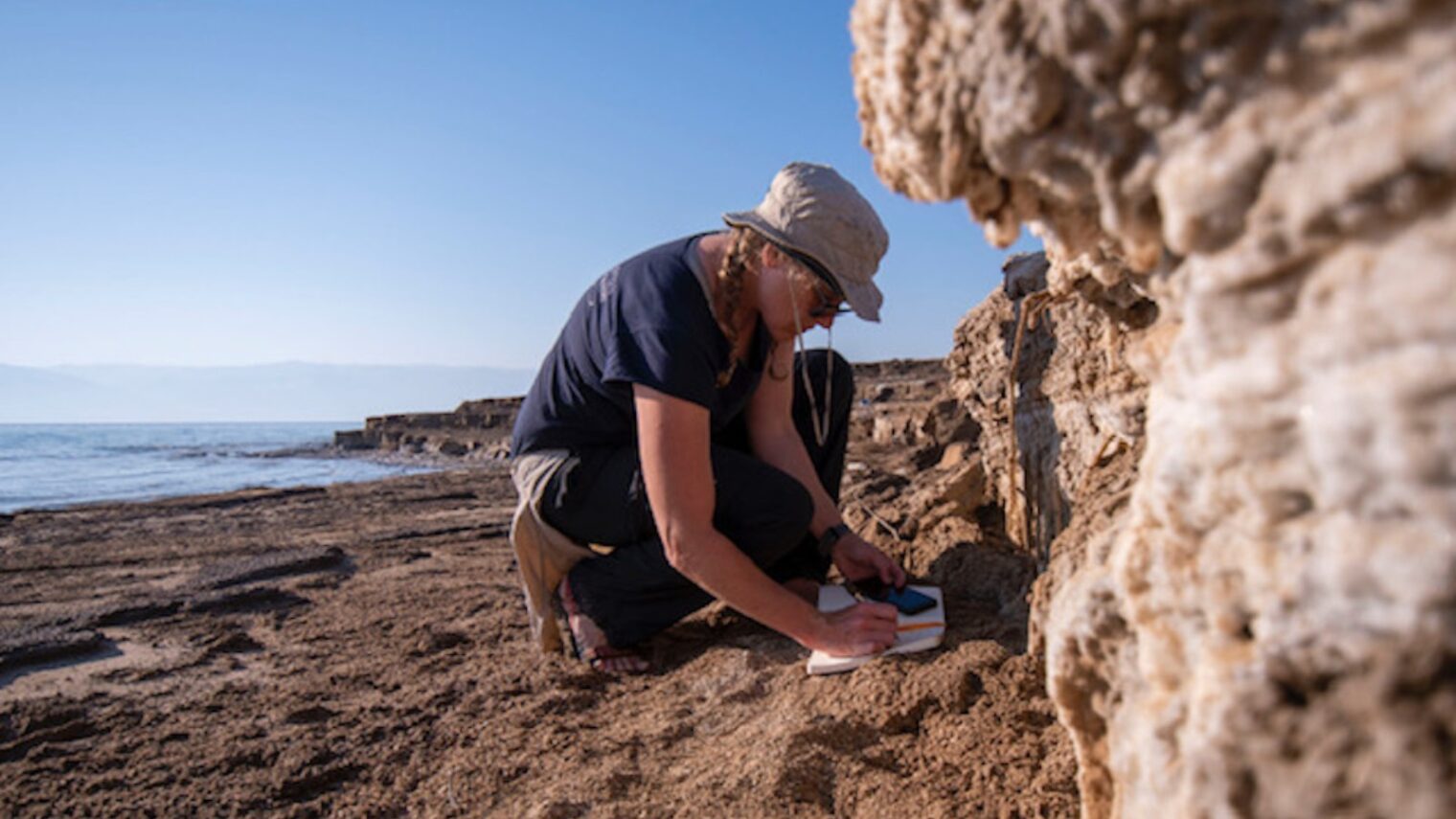 The University of Haifaâ€™s Dr. Beverly Goodman examines soil layers exposed by the retreat of the Dead Sea. Photo by Hagai Nativ/Morris Kahn Marine Research Station of University of Haifa