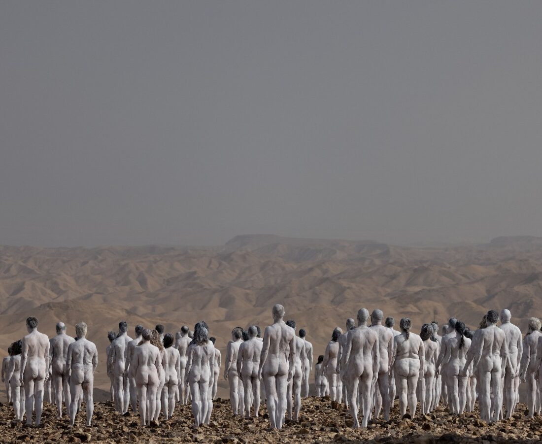 People painted in white pose for a group picture by art photographer Spencer Tunick and his team, outside Arad, October 17, 2021. Photo by Yonatan Sindel/Flash90
