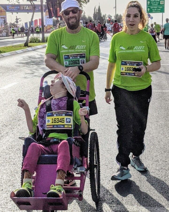 Aryeh Holtz at the International Jerusalem Marathon with twin daughters Miri and Leah. He built Leah’s running stroller from scratch. Photo courtesy of ADI