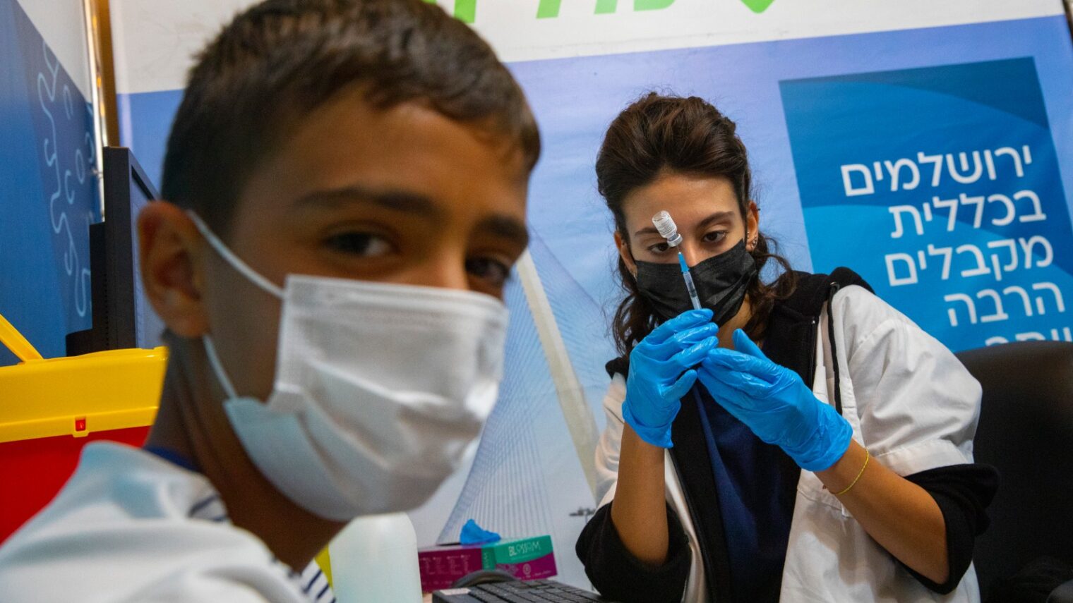 An Israeli boy receiving the Covid-19 vaccine in Jerusalem on September 20, 2021. Photo by Olivier Fitoussi/Flash90