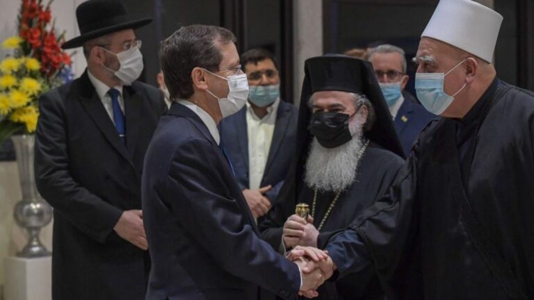 President Isaac Herzog, left, greets Israelâ€™s religious leaders during an interfaith call for Covid vaccination at his residence in Jerusalem. Koby Gideon/GPO