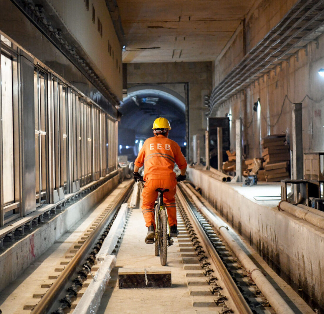 A worker cycles along the track during construction of the new Allenby underground station of the light rail red line in Tel Aviv, July 14, 2021. Photo by Yossi Zeliger/Flash90