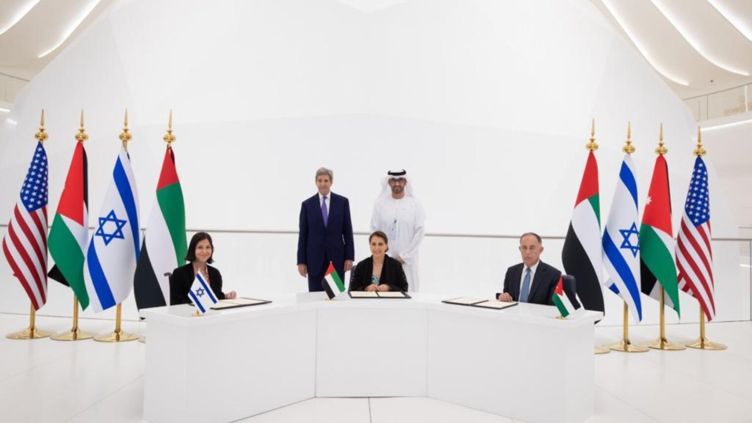 Israeli Energy and Water Resources Minister Karine Elharrar, UAE Climate Change Minister Mariam Almheiri and Jordan Water and Irrigation Minister Mohammed Al-Najjar sign a water agreement at the Dubai Expo on November 22, 2021, as US Climate Envoy John Kerry and UAE Crown Prince Mohammed bin Zayed look on. Photo courtesy of the Israeli Foreign Ministry