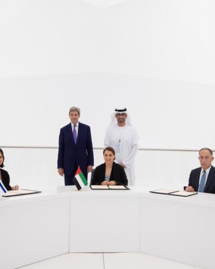 Israeli Energy and Water Resources Minister Karine Elharrar, UAE Climate Change Minister Mariam Almheiri and Jordan Water and Irrigation Minister Mohammed Al-Najjar sign a water agreement at the Dubai Expo on November 22, 2021, as US Climate Envoy John Kerry and UAE Crown Prince Mohammed bin Zayed look on. Photo courtesy of the Israeli Foreign Ministry