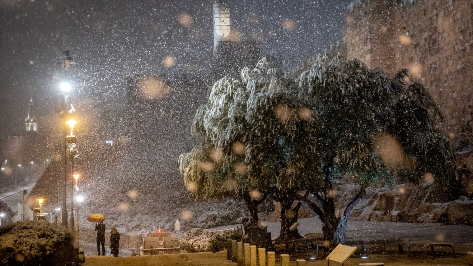 Snow falls near the Jerusalem Old city walls, as a heavy storm hits nationwide, January 26, 2022. Photo by Yonatan Sindel/Flash90