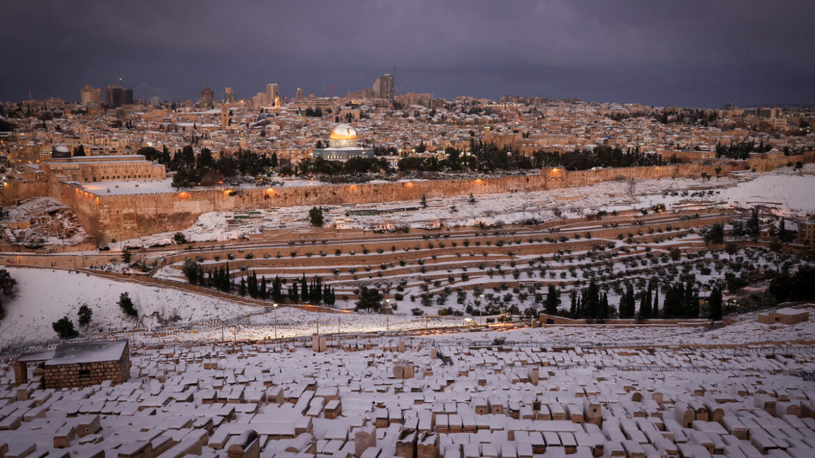The Dome of the Rock in Jerusalemâ€™s Old City as seen from a snow covered Mount of Olives during a storm on January 27, 2022. Photo by Nati Shohat/Flash90