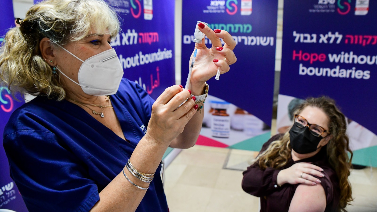 Healthcare workers receive a Moderna booster vaccine at Sheba Medical Center on January 5, 2022. Photo by Avshalom Sassoni/Flash90