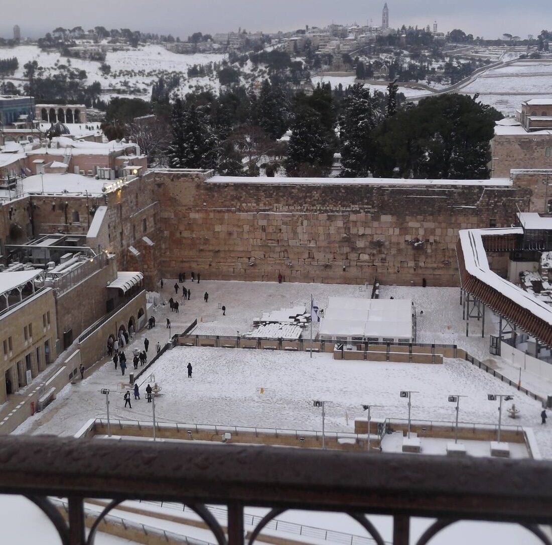 Snow falls on the Western Wall and Dome of the Rock. Photo by Chaya Weisberg/Heritage House