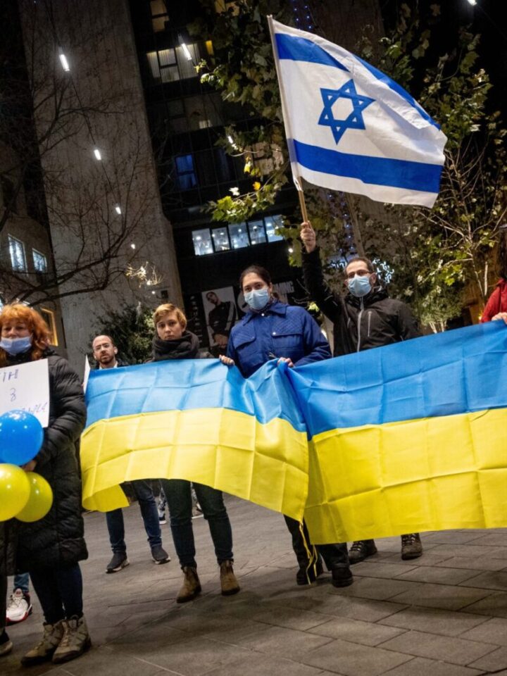 Demonstrators carry placards and flags during a protest against the Russian invasion to the Ukraine, in Jerusalem, on February 24, 2022. Photo by Yonatan Sindel/Flash90
