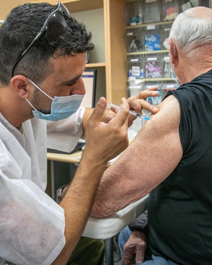 An Israeli man receiving a dose of the Covid-19 vaccine at a temporary Maccabi healthcare center in Rehovot, January 10, 2022. Photo by Yossi Aloni/Flash90