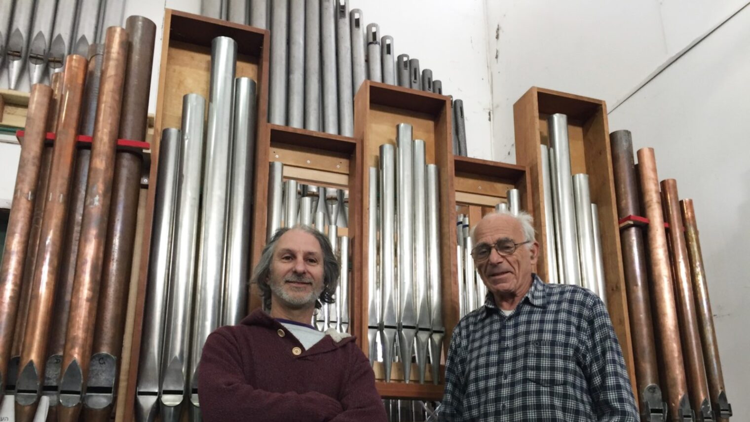 Uri Shani, left, and Gideon Shamir in front of organ pipes they will restore. Photo by Diana Bletter