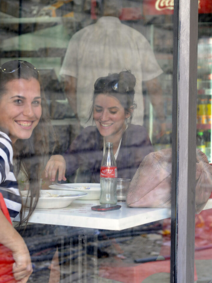 Two women sit at a cafe on Hillel Street in Jerusalem. Photo by Louis Fisher/Flash90.