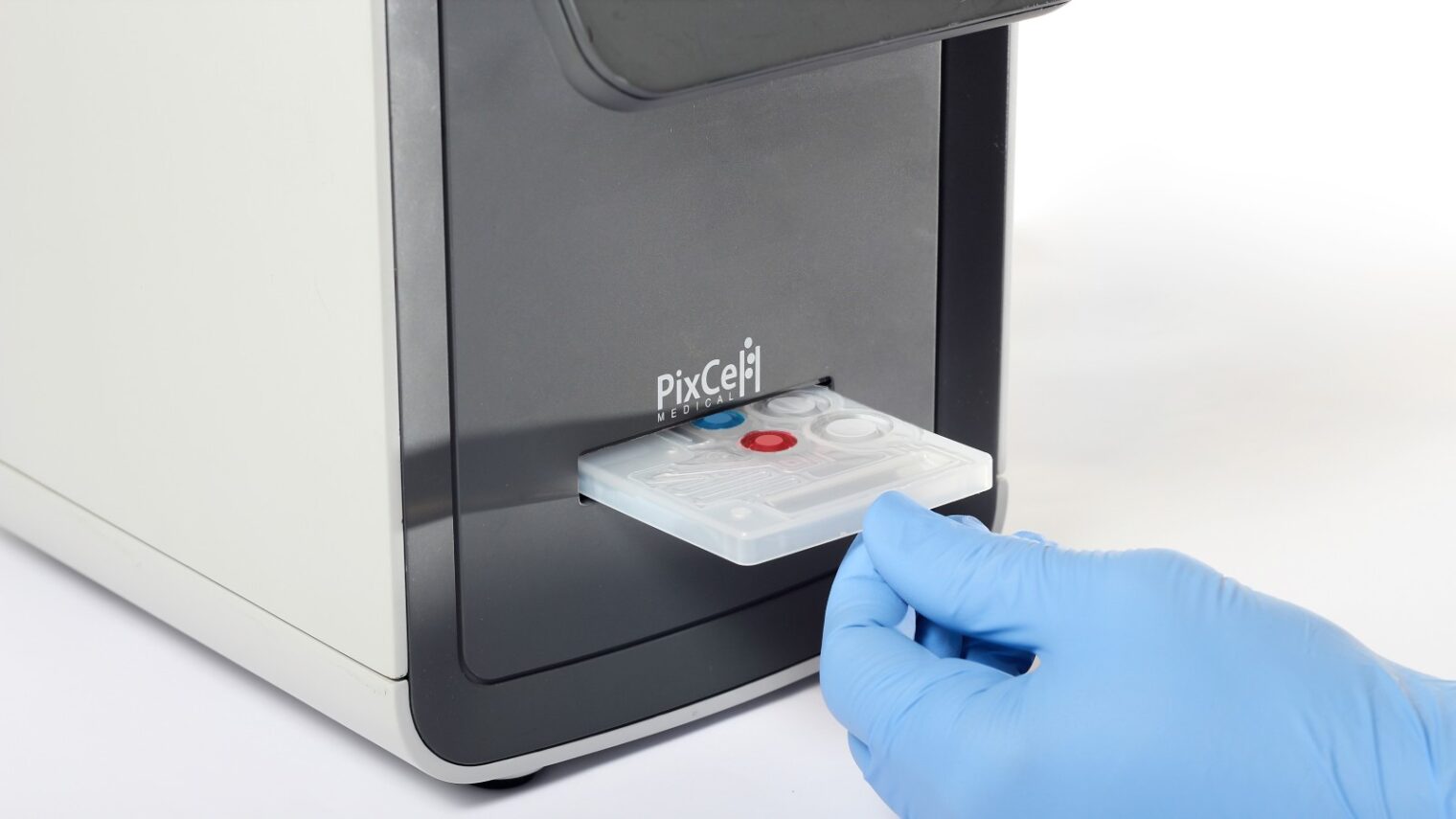 Inserting the disposable blood sample cartridge into the HemoScreen. Photo courtesy of PixCell