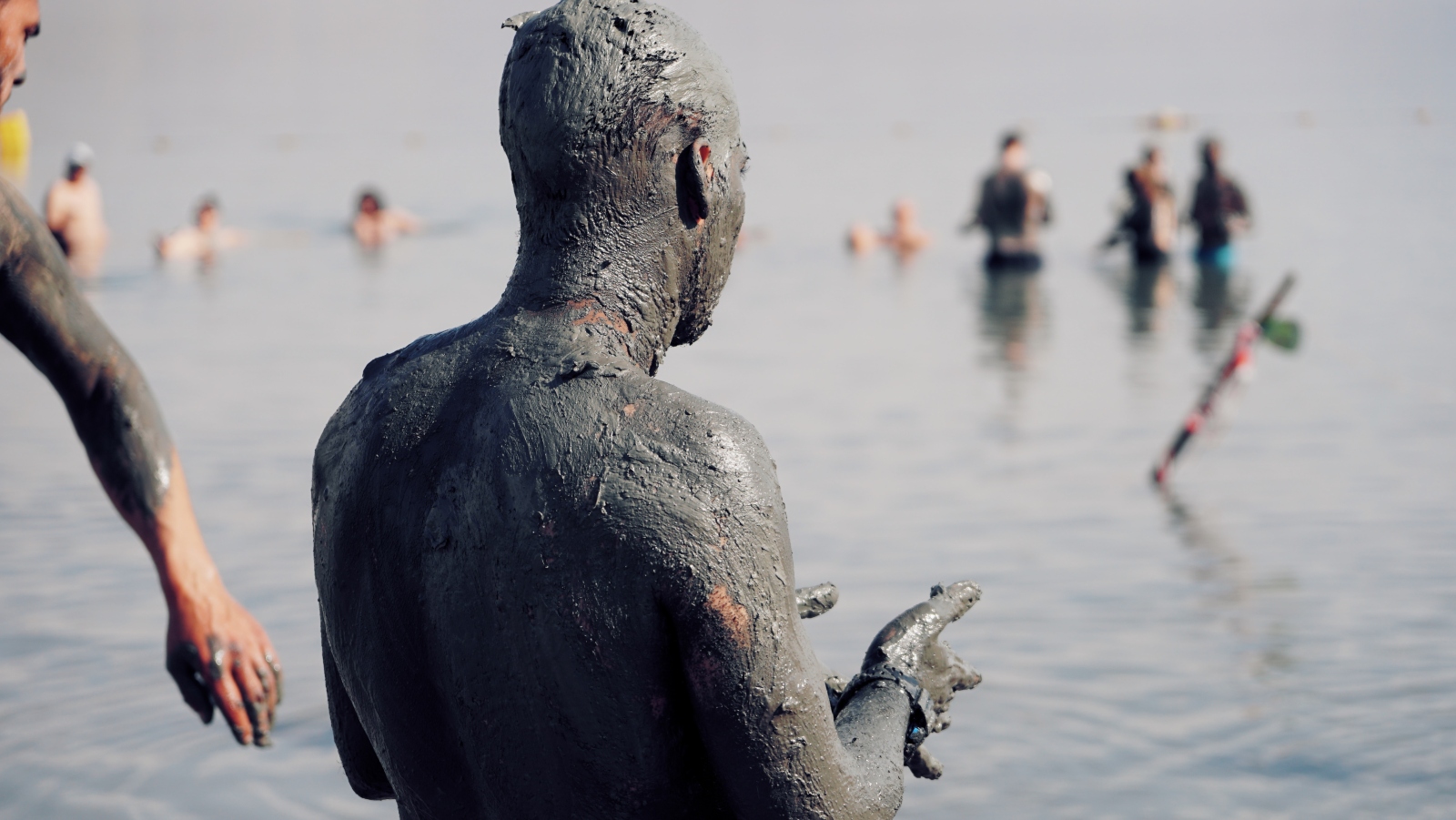 Photo of a Dead Sea bather by Drew Gilliam on Unsplash