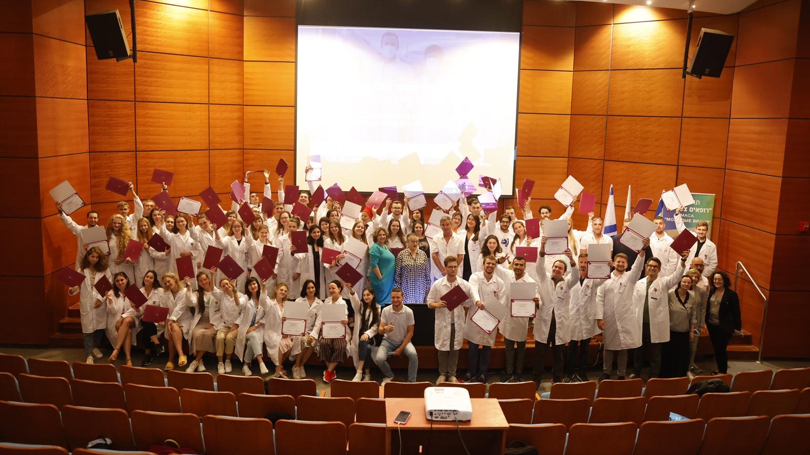 Seventy Eastern European immigrants celebrating the completion of the Physicians Program at Rambam Health Care Campus. Photo by Olivier Fitoussi