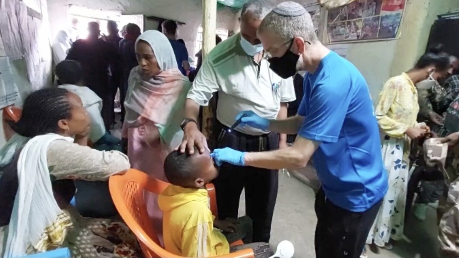 Dr. Morris Hartstein doing an eye exam in the village of Azzezo, Ethiopia. Photo courtesy of Operation Ethiopia