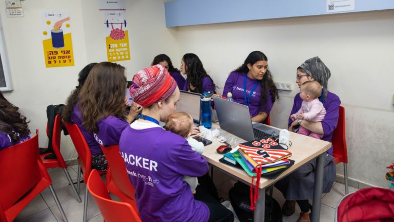 Orthodox women, some with babies, at the JCT LevTech Entrepreneurship Center’s hackathon. Photo by Michael Erenburg