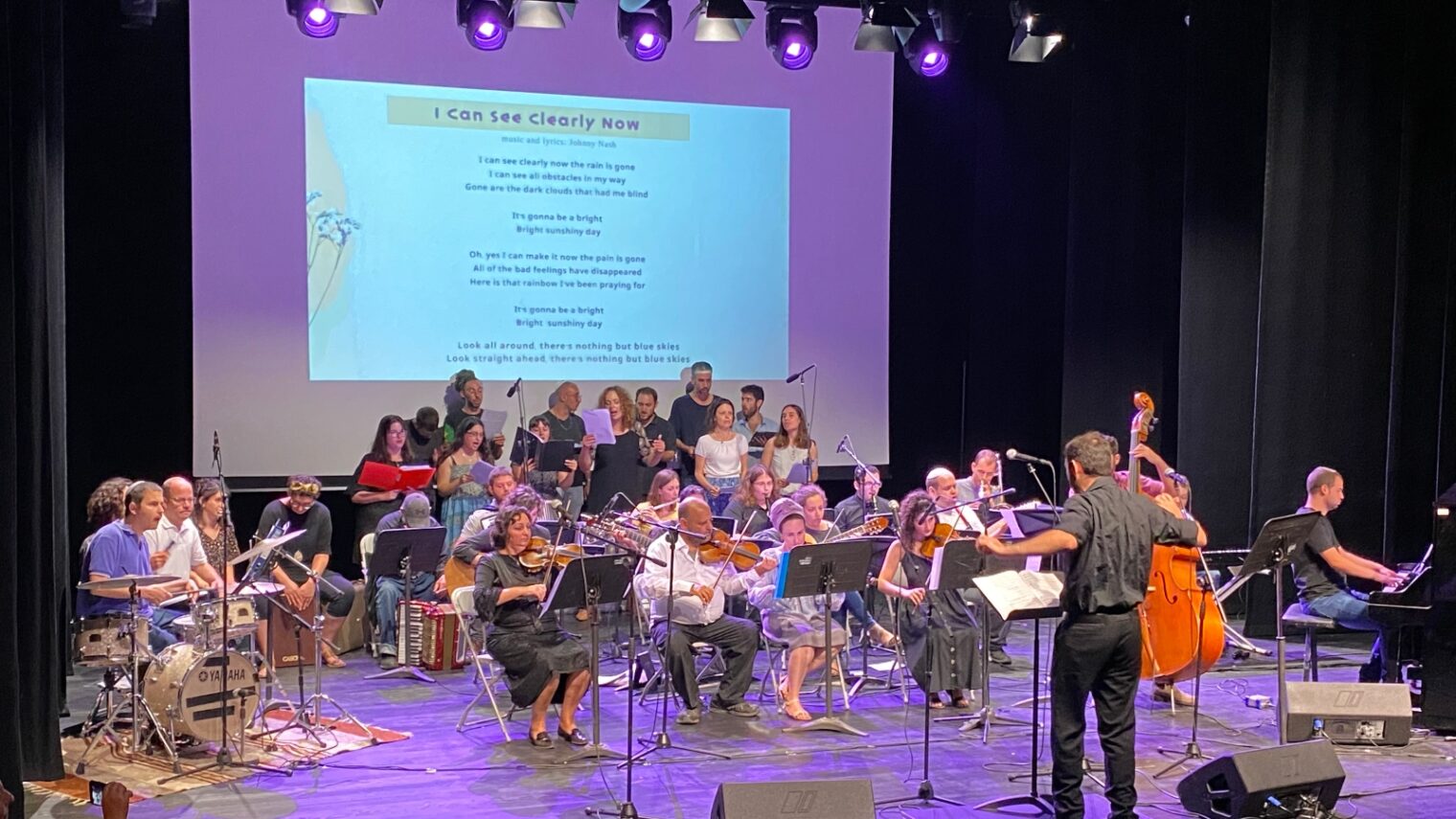 Israel Inclusion Orchestra conductor Ido Marco leading the musicians and vocalists in â€œI Can See Clearly Now.â€� Photo by Abigail Leichman