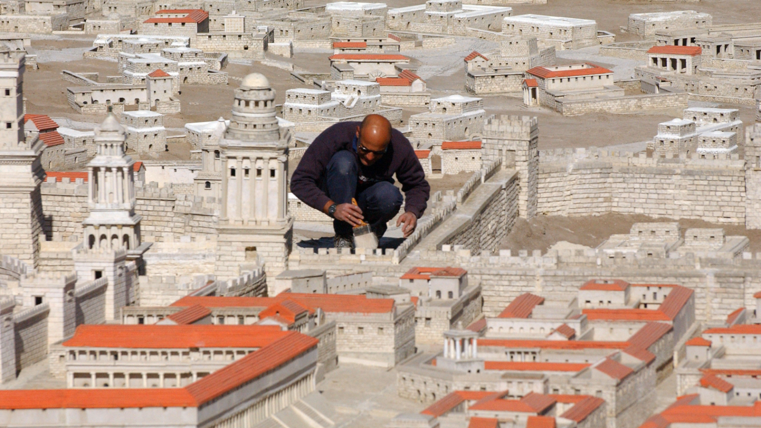 Painting the model of Jerusalem at the time of the Second Temple that was moved from the Holyland Hotel to the Israel Museum in 2009. Photo by Yossi Zamir/Flash90