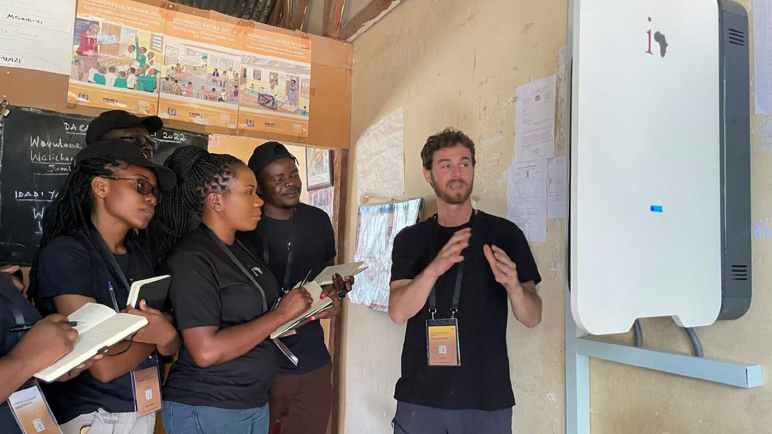 Electromechanical engineer Ben Fuxbrunner explaining his project in Tanzania to local students. Photo courtesy of Innovation: Africa