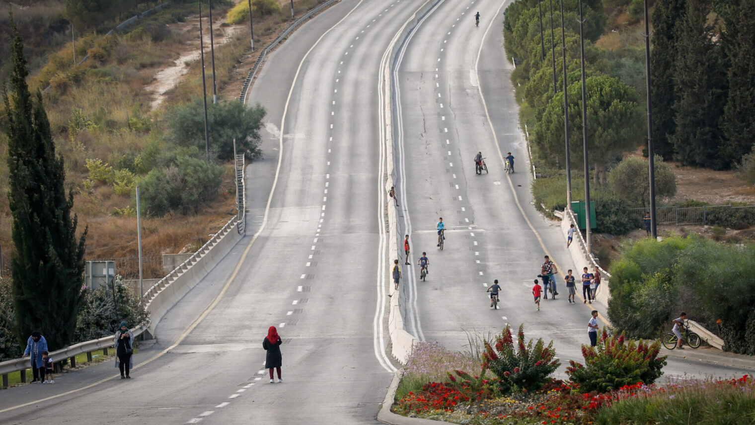 Children ride their bicycles along the empty Jerusalem roads on Yom Kippur, the Day of Atonement, and the holiest of Jewish holidays. Photo by Jamal Awad/Flash 90 