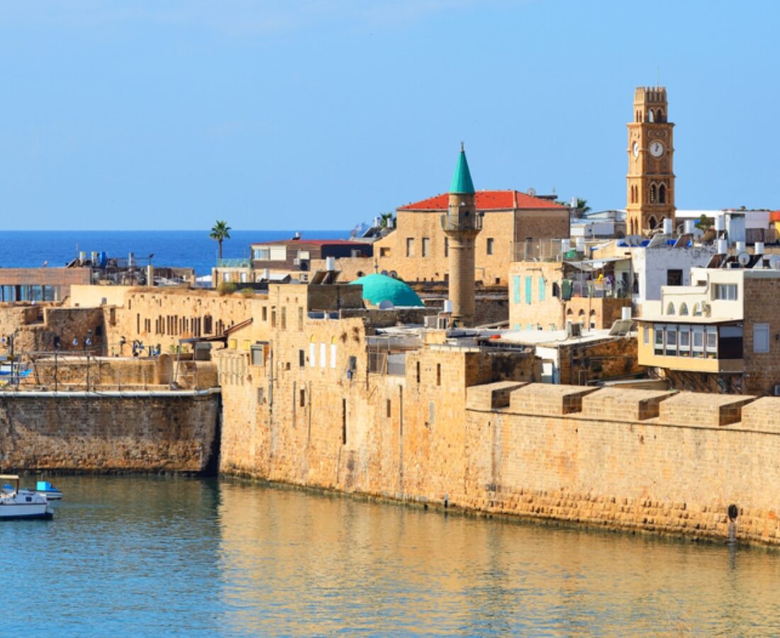 A view of Akko’s harbor, walls and houses of worship. Photo by Alex7370 via Shutterstock.com