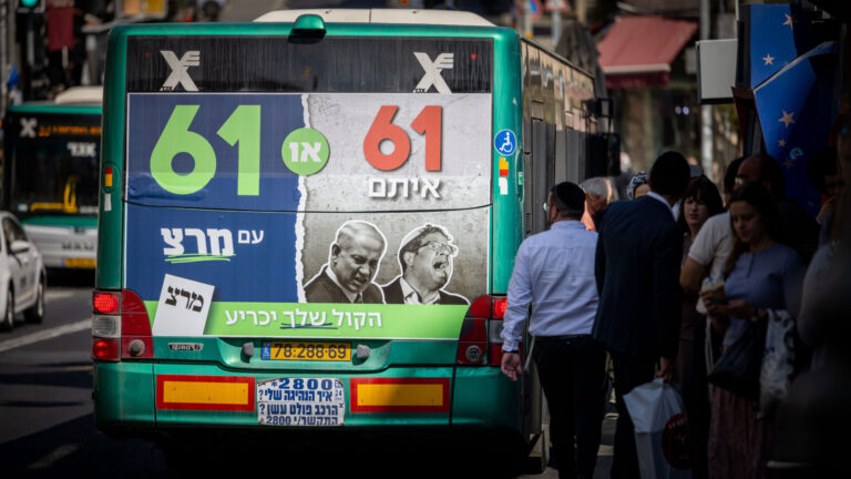 The all-important figure of 61. Will any party make it this time? A bus drives through Jerusalem with a large election poster from the political party Meretz. Photo by Yonatan Sindel/Flash90
