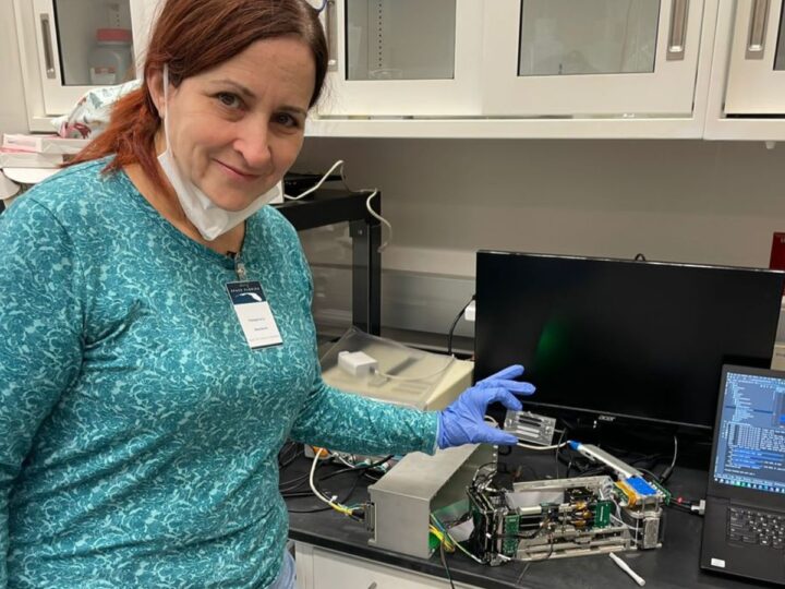 Prof. Sara Eyal with a miniaturized and remote control lab launched to the International Space Station in 2022. Photo by Emile Kan